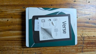 a tablet computer sitting on top of a wooden table
