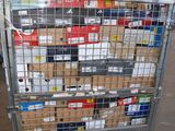 a metal cart with many boxes on it in a warehouse