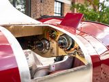 a close up of a red and white car with a steering