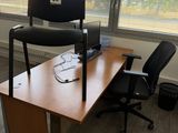 a desk with a chair and a computer on it