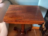a small table with a wooden top on a hard wood floor