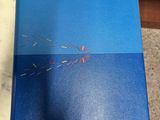 a close up of a blue book on a marble table