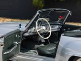 an image of a car with the door open and the driver ' s seat down