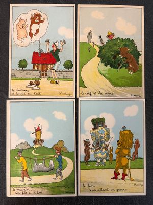 four cards with pictures of people and animals on them on a table