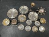 a lot of silver dishes on a black table