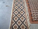 two rugs on the floor in a room with a blue tag on the floor