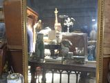 a mirror that is sitting on a table with a plate on it