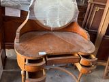 a wooden vanity with a mirror on top of it