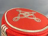 a red hat with a white monogram on it