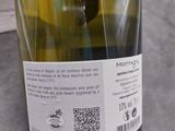 a bottle of wine sitting on a table next to a bottle of wine