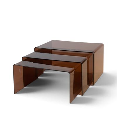 three brown glass nesting tables on a white background
