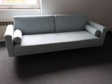 a couch that is sitting in a room by a window