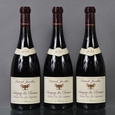 three bottles of wine are lined up on a table