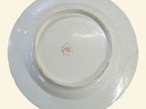 a white plate with a brown design on it