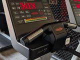 a row of tread machines in a gym room