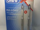 two toothbrushes in a box on a white background