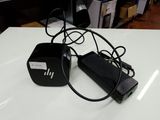 a black power cord that is plugged into a charger on a table