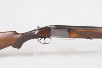 a rifle with a wooden barrel and a wooden handle