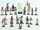 a lot of figurines that are on a white surface
