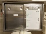 a white board on the wall of a public restroom