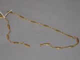 a gold chain that has been placed on a table