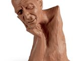statue of a man with his chin resting on his hand