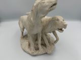 a figurine of a dog and a cat on a table