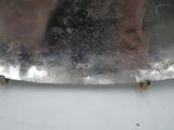 a close up of a metal object on a white surface