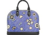 the blue handbag has a pattern on it and a black handle