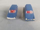 two toy cars that are sitting next to each other