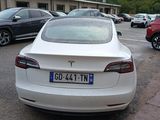 a white tesla model s parked in a parking lot