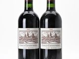 two bottles of red wine sitting next to each other on a white surface