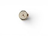 a close up of a watch on a white surface with a white background