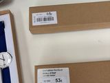 three watches are sitting on top of a cardboard box on a table