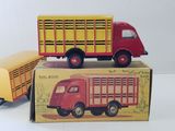 two toy trucks sitting on top of each other on a table