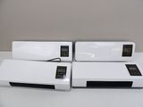 three white air conditioners sitting on top of a white table