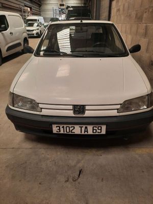 the white car is parked in a garage with other cars in the background