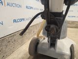 a machine that is sitting on the ground in front of a wall