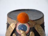 an orange sitting on top of a hat on a table