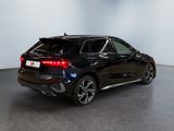 the rear end of a black bmw suv parked in a showroom
