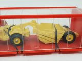 quelqu'un tient un camion miniature à l'intérieur d'un conteneur rouge