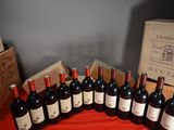 several bottles of red wine are lined up on a table