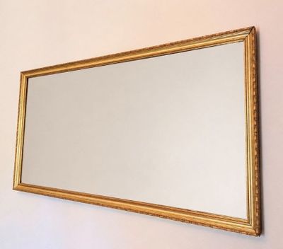 a mirror hanging on the wall in a room