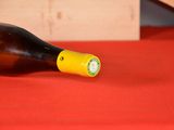 a bottle of wine sitting on a red table
