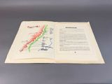 an open book with a map on it sitting on a table