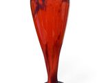 a red and blue vase sitting on a white surface