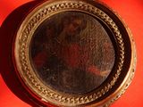 a picture of jesus in a gold frame on a red background