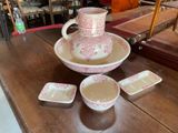 a table with a bowl, cups, and a pitcher on it