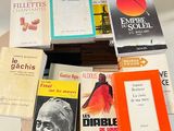 several books are stacked on top of each other on a table