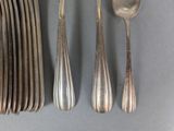several spoons, forks and spoons are lined up on a table